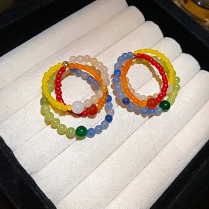 Colorful natural stone beaded earrings with silver needles in a jewelry display box