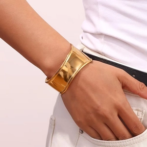 Polished 18K gold plated wide cuff bracelet featuring minimalist wavy dot pattern for women