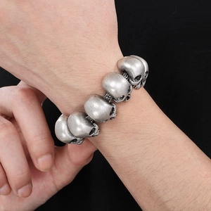 Close-up of vintage silver skull link bracelet showing detailed punk gothic craftsmanship