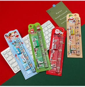 Detailed Christmas stationery set including pencils and ruler over a white keyboard