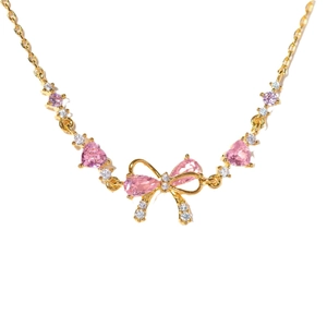 Elegant gold bow necklace featuring pink heart-shaped crystals and sparkling zircon accents