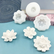 Three sizes of lotus flower silicone molds shown with finished white wax candle samples