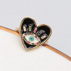 Macro detail of gold-plated heart ring with evil eye enamel and micro-pave zircons