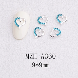 Detail view of 9mm hollow heart nail art charms with light blue rhinestones in silver setting