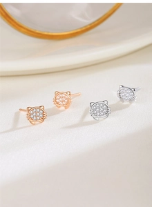 Macro shot of silver and rose gold cat stud earrings with sparkling white cubic zirconia