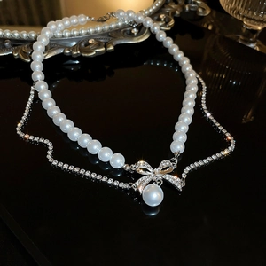 Double-layer pearl necklace with sparkling crystal bow pendant and silver-tone finish