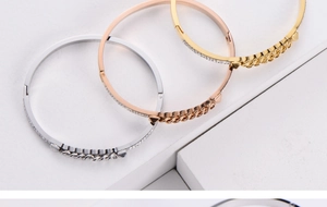 Macro shot of titanium steel bracelets in gold, silver and rose gold with chain detail