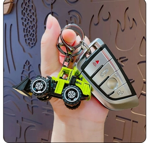 Miniature lime green excavator keychain with metal ring and lobster clasp detail