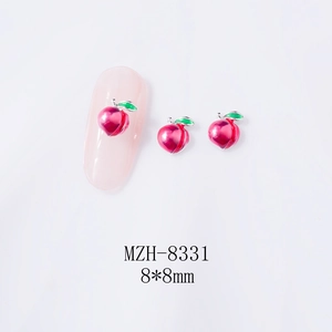 Close-up of 8x8mm peach nail charms with red alloy finish and green leaf details
