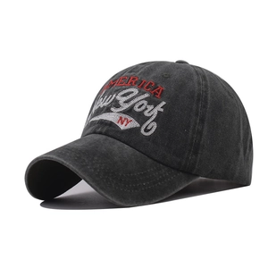 Detail of embroidered New York and America text on washed cotton baseball cap