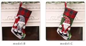 Detail of Christmas gnome stockings with red and green plaid cuffs on a fireplace