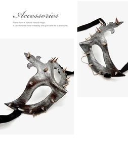 Detail of vintage punk half-face mask with silver brushed texture and metal chain