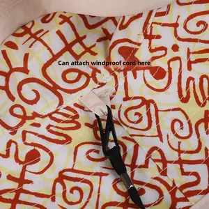 Detail view of windproof rope hook and beige strap on nylon sun hat interior