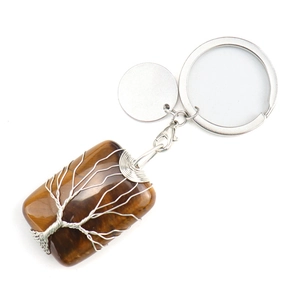 Detailed macro shot of handmade tiger eye stone keychain with wire wrapped tree of life