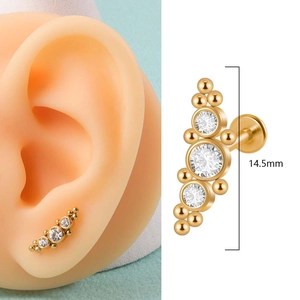 Golden 316L stainless steel labret with curved crystal clusters and gold bead details