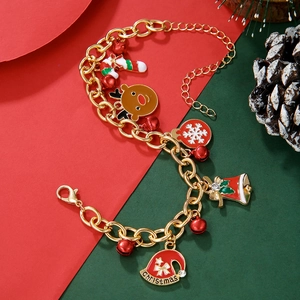 Close-up of gold festive bracelet with Christmas charms like reindeer and snowflakes