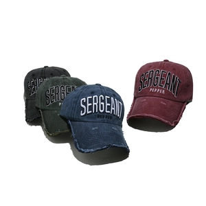 Detail view of four vintage baseball caps with Sergeant Pepper embroidery and distressed brims