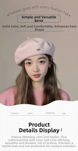 Detailed macro view of pink wool beret with small metal logo tag and soft texture