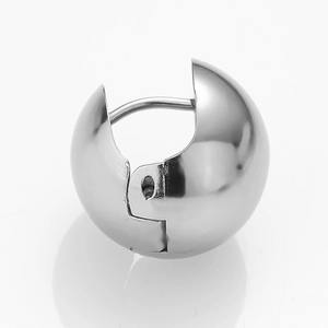 Close-up of polished silver sphere huggie earring with a minimalist hinged design