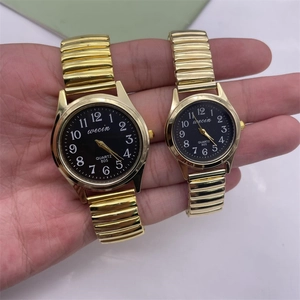 Detail of gold elastic band quartz watches with black dial and white numerals