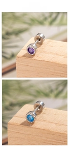 Detail of silver round zircon cartilage studs in purple and blue with screw backs