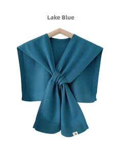 Detail showing lake blue knitted shawl with ribbed edges and cross-knot design