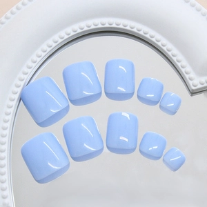 Minimalist light blue press-on toe nails displayed on a white pearl mirror tray