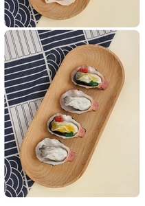 Detailed view of artificial grilled oysters with realistic garlic toppings on a wooden tray