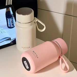 Minimalist cream and pink stainless steel vacuum bottles with portable handles and tea filters