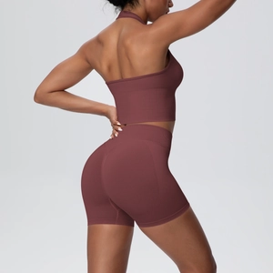 Detailed side view of seamless knit yoga set featuring halter top and scrunch shorts