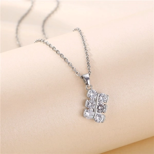 Minimalist silver titanium necklace with double-row zircon pendant on beige background