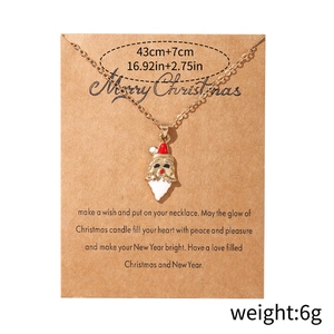 Enamel Santa Claus pendant necklace with golden chain on craft card display