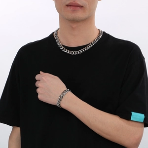Ensemble collier et bracelet à mailles cubaines en acier poli sur un mannequin
