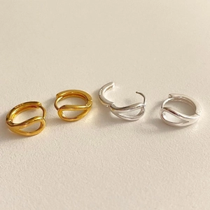 Close-up of dual-line cross hoop earrings in polished gold and silver 925 sterling silver