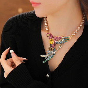 Close-up of vintage parrot pendant necklace with colorful rhinestones and gold pearls