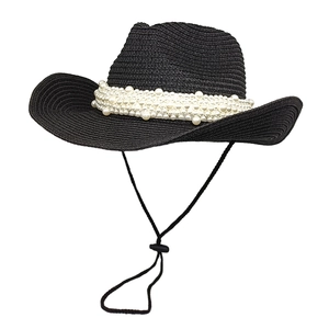 Chic black straw cowgirl hat with white pearl trim and adjustable chin strap for women