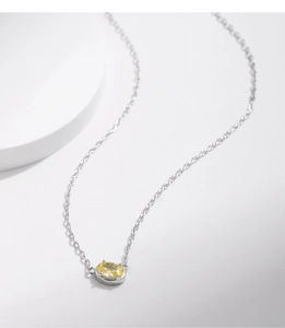 Detail of s925 silver necklace with sparkling yellow oval-cut gemstone pendant