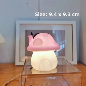 Detail showing pink mushroom night light dimensions of 9.4cm x 9.3cm on wooden table