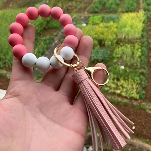 Close-up of pink silicone beads and marble pattern beads with PU tassel on a keychain