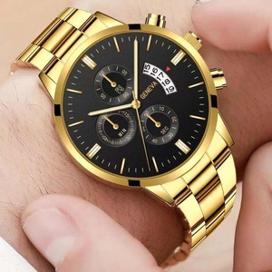 Macro shot of Geneva men's gold watch with black dial and three-eye calendar display