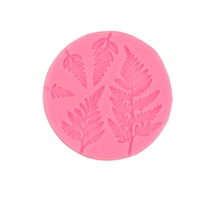 Pink silicone mold featuring tropical fern leaf patterns for fondant cake decoration