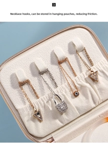Detail of velvet jewelry box with four necklace hooks and storage pouches