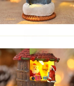 Detail of a resin GIFT SHOP miniature with warm lights, glitter snow, and woven base texture