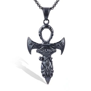 Macro shot of stainless steel Eye of Horus and Ankh pendant with feather details