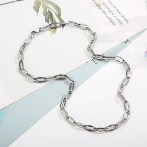 Detailed view of silver interlocking geometric chain links of a titanium steel necklace