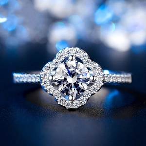 Exquisite clover flower ring with central diamond and brilliant halo setting