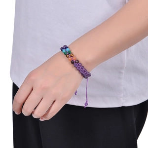 Detail of multi-color gemstone braided bracelet featuring a purple adjustable sliding knot