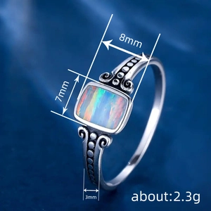 Vintage style ring with rectangular opal stone and ornate floral engraved silver band