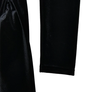 Detailed close-up of the black shiny velvet sleeve stitching on the slim fit dress