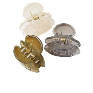Three translucent mini hair claw clips in beige, grey, and olive green for high ponytails